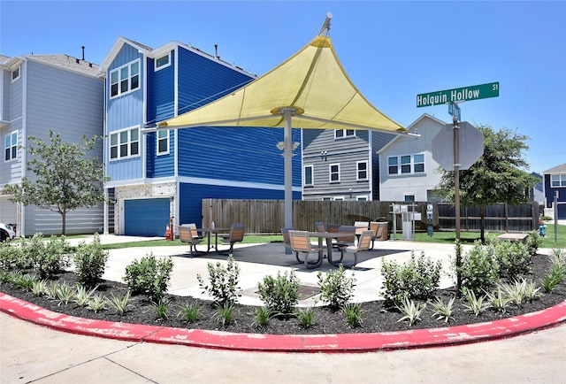 5502 Camaguey St, Houston, TX 77023 - view of property's community with fence, a patio area, and a garage
