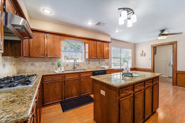 1618 Monroe Dr, Deer Park, TX 77536 - kitchen with a sink, ventilation hood, a center island, plenty of natural light, and wainscoting