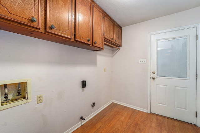 1618 Monroe Dr, Deer Park, TX 77536 - clothes washing area featuring cabinet space, washer hookup, light wood-style flooring, baseboards, and gas dryer hookup