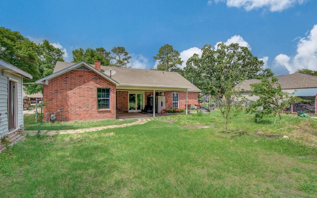 2915 Quailwood St, Houston, TX 77014 - back of house with a chimney, a yard, brick siding, and a patio