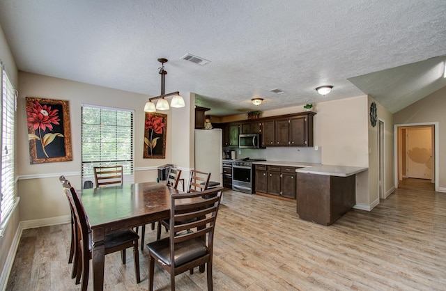 2915 Quailwood St, Houston, TX 77014 - dining room with light wood finished floors, baseboards, and a textured ceiling