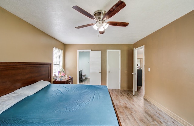 2915 Quailwood St, Houston, TX 77014 - bedroom featuring light wood-style flooring, baseboards, ensuite bathroom, and a ceiling fan
