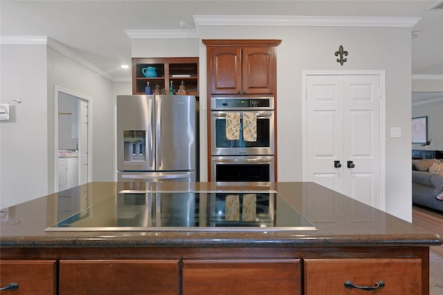12915 Birch Falls Rd, Houston, TX 77065 - kitchen with stainless steel appliances, ornamental molding, dark stone counters, and a kitchen island