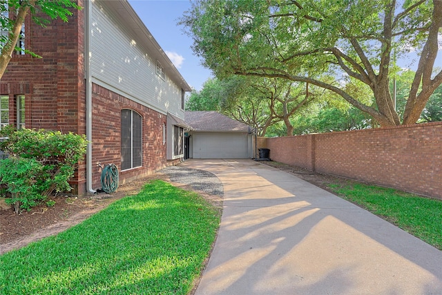 12915 Birch Falls Rd, Houston, TX 77065 - view of home's exterior featuring driveway, fence, brick siding, and a garage