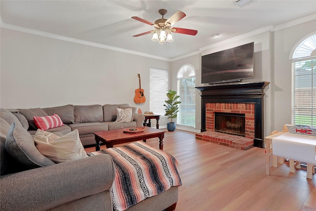 12915 Birch Falls Rd, Houston, TX 77065 - living room with light wood-style floors, ornamental molding, ceiling fan, a fireplace, and baseboards