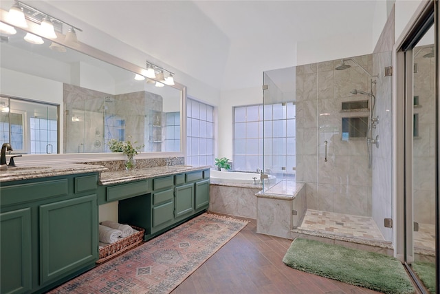 12915 Birch Falls Rd, Houston, TX 77065 - bathroom featuring a shower stall, wood finished floors, a garden tub, and double vanity