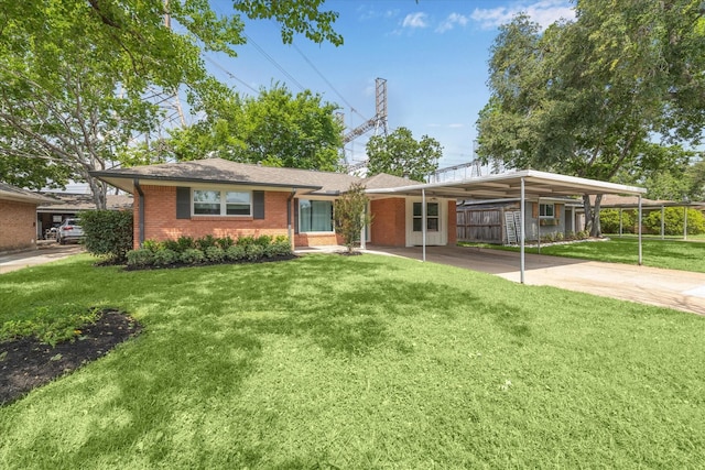 single story home with a front lawn, concrete driveway, brick siding, and an attached carport