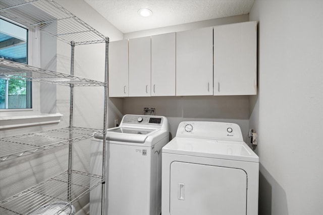 laundry room with washer and clothes dryer and cabinet space