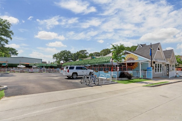 uncovered parking lot featuring fence