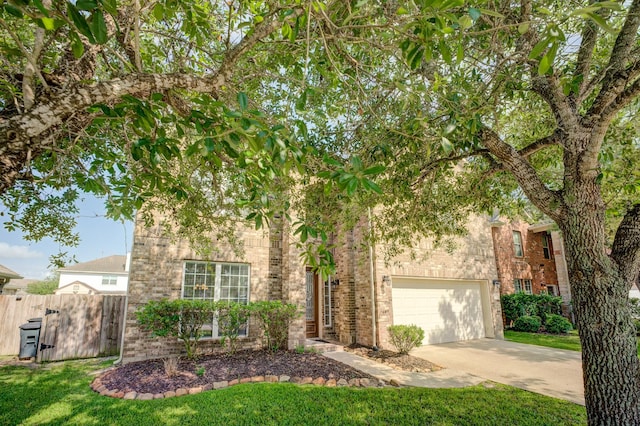 8246 Mandalay Bay Dr, Baytown, TX 77523 - view of front of home with brick siding, driveway, and an attached garage