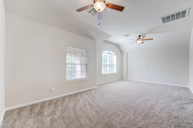 8246 Mandalay Bay Dr, Baytown, TX 77523 - carpeted empty room featuring vaulted ceiling, a ceiling fan, and baseboards