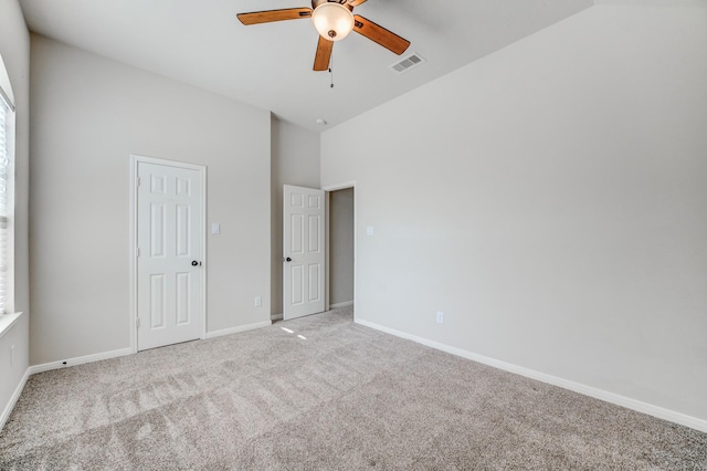 8246 Mandalay Bay Dr, Baytown, TX 77523 - unfurnished bedroom with light colored carpet, baseboards, a high ceiling, and ceiling fan