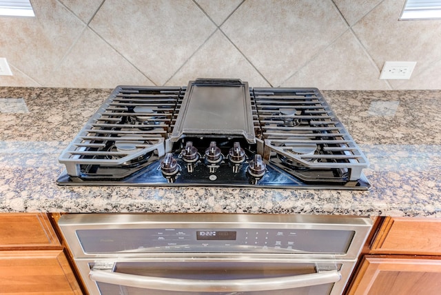 8246 Mandalay Bay Dr, Baytown, TX 77523 - kitchen view of black stovetop and stainless steel oven