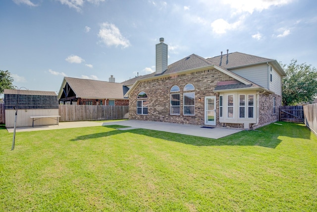 8246 Mandalay Bay Dr, Baytown, TX 77523 - rear view of property featuring a patio, brick siding, a storage shed, a chimney, and an outdoor structure