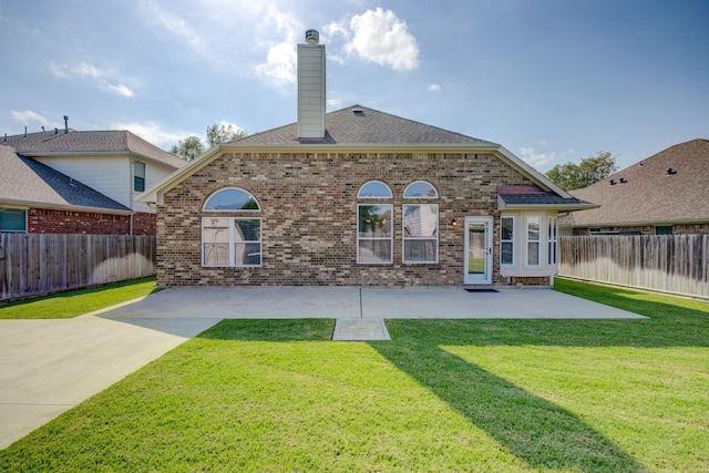 8246 Mandalay Bay Dr, Baytown, TX 77523 - rear view of property featuring brick siding, a chimney, a patio, and a shingled roof