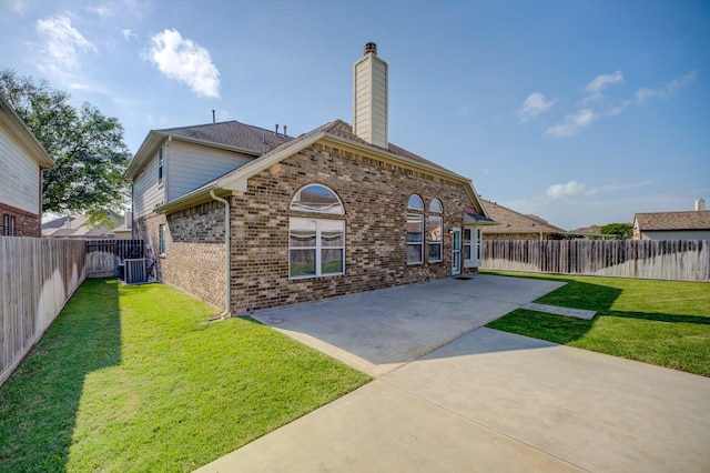 8246 Mandalay Bay Dr, Baytown, TX 77523 - rear view of property featuring a patio area, central air condition unit, brick siding, and a chimney
