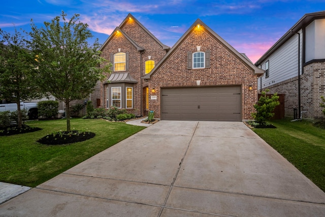 traditional-style home featuring brick siding, a yard, and concrete driveway