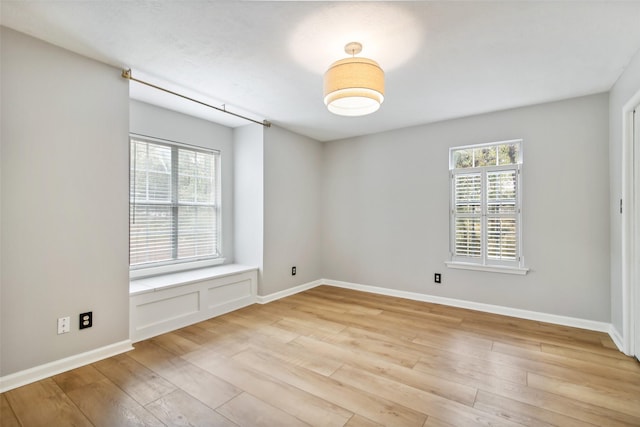 28 Stony Creek Dr, Conroe, TX 77384 - empty room featuring plenty of natural light, light wood-style floors, and baseboards