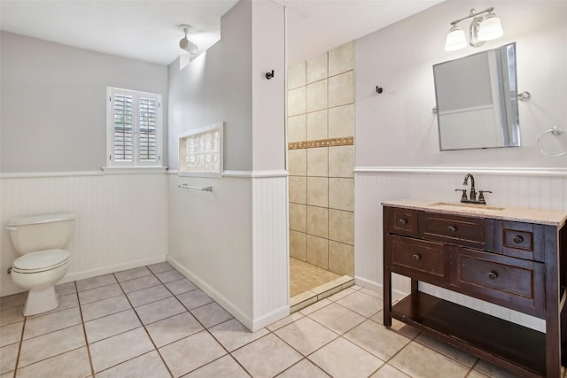 28 Stony Creek Dr, Conroe, TX 77384 - full bath with tile patterned flooring, a walk in shower, toilet, wainscoting, and vanity