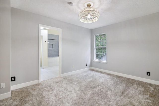 28 Stony Creek Dr, Conroe, TX 77384 - unfurnished room featuring carpet, a chandelier, and baseboards