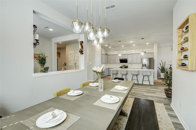 2815 Torrey Pines Dr, Fulshear, TX 77423 - dining space with light wood-type flooring, recessed lighting, and baseboards