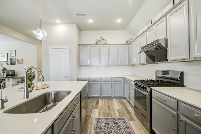 2815 Torrey Pines Dr, Fulshear, TX 77423 - kitchen featuring stainless steel appliances, a sink, gray cabinetry, light wood-type flooring, and under cabinet range hood