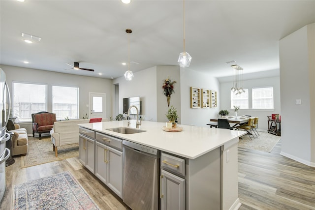 2815 Torrey Pines Dr, Fulshear, TX 77423 - kitchen with stainless steel dishwasher, gray cabinetry, a sink, open floor plan, and recessed lighting