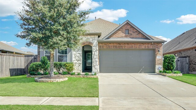 2815 Torrey Pines Dr, Fulshear, TX 77423 - french country home featuring stone siding, an attached garage, brick siding, and driveway