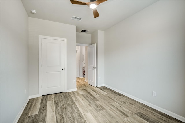 2815 Torrey Pines Dr, Fulshear, TX 77423 - unfurnished bedroom with wood finished floors, baseboards, and ceiling fan