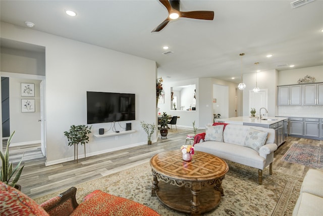 2815 Torrey Pines Dr, Fulshear, TX 77423 - living area with light wood-type flooring, ceiling fan, baseboards, and recessed lighting