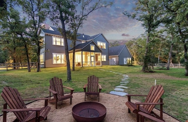 3923 Millican Creek Trl, College Station, TX 77845 - back of house at dusk featuring a fire pit