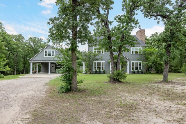 3923 Millican Creek Trl, College Station, TX 77845 - view of front of house with dirt driveway, a front yard, and a chimney