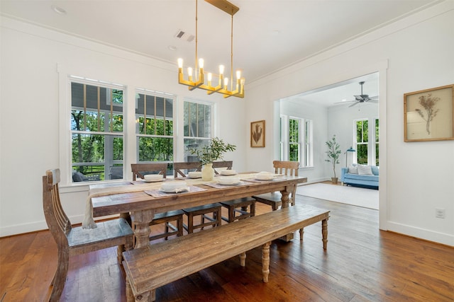 3923 Millican Creek Trl, College Station, TX 77845 - dining area featuring crown molding, hardwood / wood-style floors, baseboards, and a chandelier