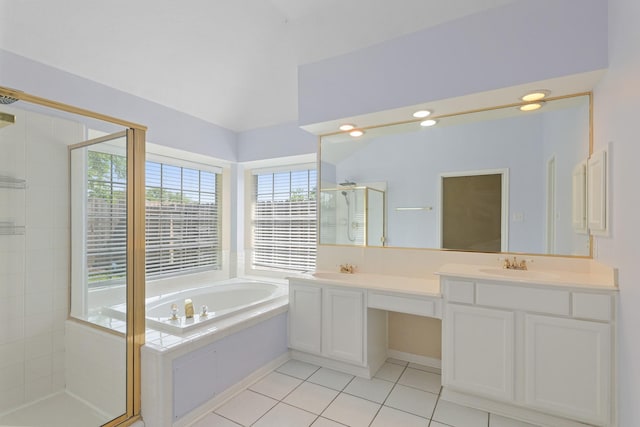 full bathroom featuring a shower stall, vaulted ceiling, a garden tub, tile patterned flooring, and double vanity