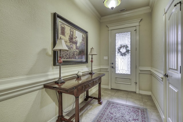 foyer entrance featuring light tile patterned floors and ornamental molding