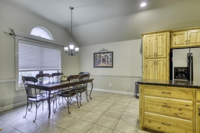 dining room with vaulted ceiling, light tile patterned flooring, a chandelier, plenty of natural light, and baseboards