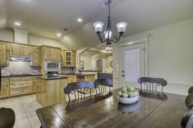 dining area featuring a chandelier, arched walkways, vaulted ceiling, light tile patterned floors, and recessed lighting