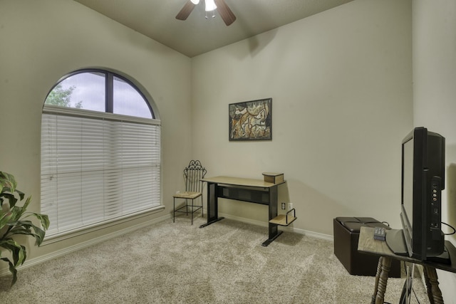 living area with a ceiling fan, carpet floors, lofted ceiling, baseboards, and a desk
