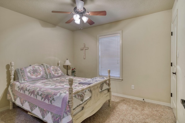 bedroom featuring carpet flooring, baseboards, a ceiling fan, and a textured ceiling