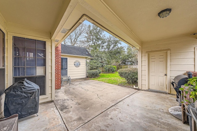 view of patio with a grill and fence