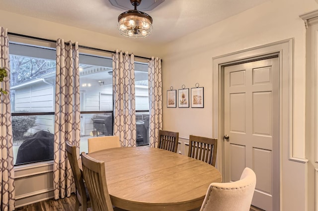 dining area featuring dark wood-type flooring