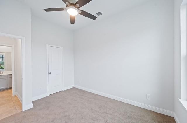 18127 Shoreline Vista Ln, Cypress, TX 77433 - unfurnished bedroom with light colored carpet, baseboards, and ceiling fan