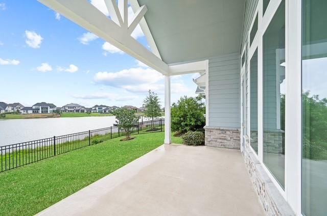 18127 Shoreline Vista Ln, Cypress, TX 77433 - view of patio / terrace with a water view and a residential view