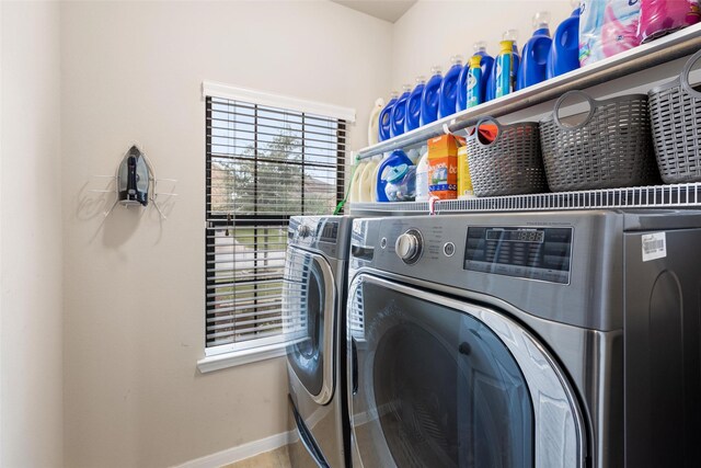 laundry room featuring washer and dryer and baseboards
