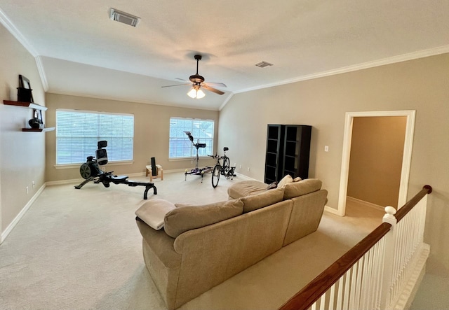 carpeted living area featuring crown molding, baseboards, ceiling fan, and vaulted ceiling