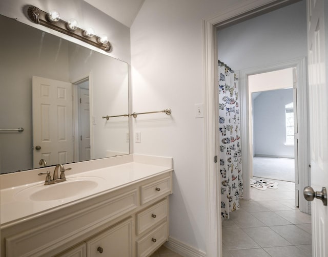bathroom featuring vanity, tile patterned floors, and baseboards