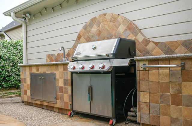 view of patio featuring area for grilling and a grill