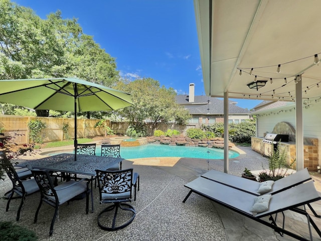 view of pool with exterior kitchen, a fenced backyard, a patio, an in-ground hot tub, and a grill