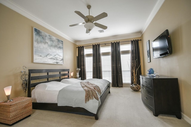 bedroom featuring ornamental molding, light colored carpet, and a ceiling fan