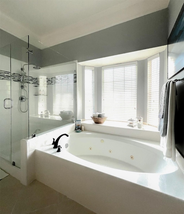 full bathroom featuring a stall shower, plenty of natural light, a jetted tub, and tile patterned floors